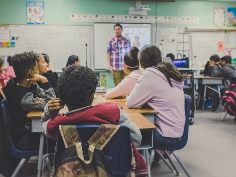 Students in a classroom using laptops for digital learning
