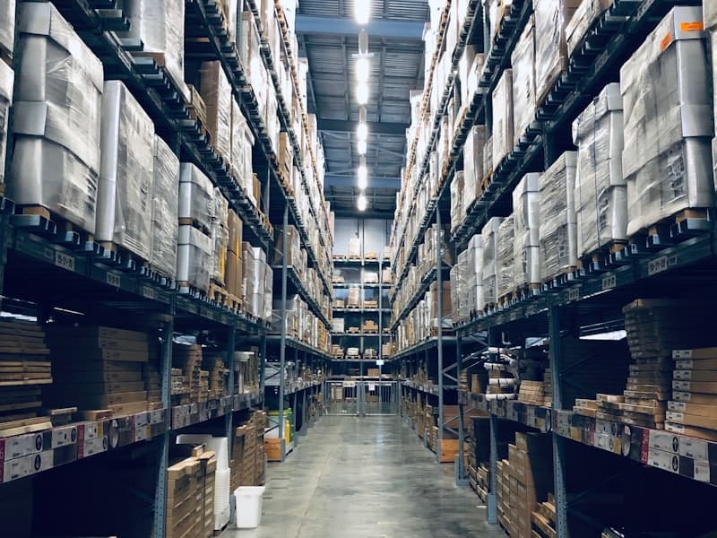 Warehouse worker scanning inventory on shelving racks